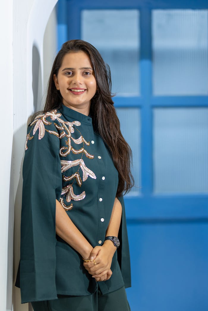 Portrait of an Indian woman in stylish embroidered outfit, exuding elegance.